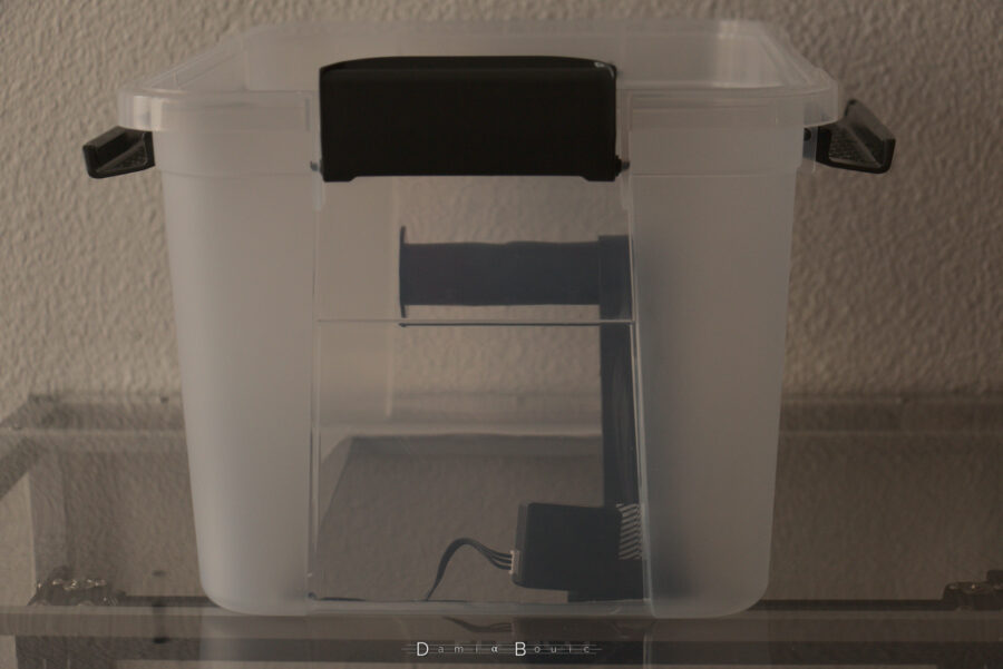 La même boite, mais à l'endroit, dont le fond ouvert permet le passage du support à filament. Le couvercle n'est pas posé dessus.